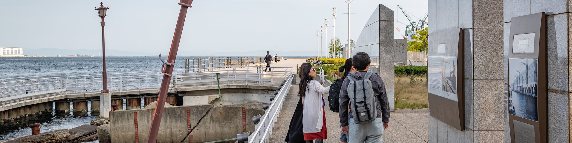 Port of Kobe Earthquake Memorial showing general coastal views as well as a small group of people