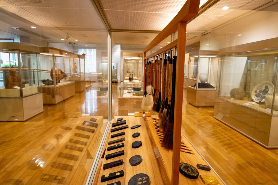 A museum interior with wooden displays and glass cases.