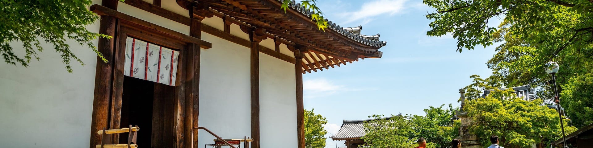A traditional Japanese building with wooden beams and a tiled roof.