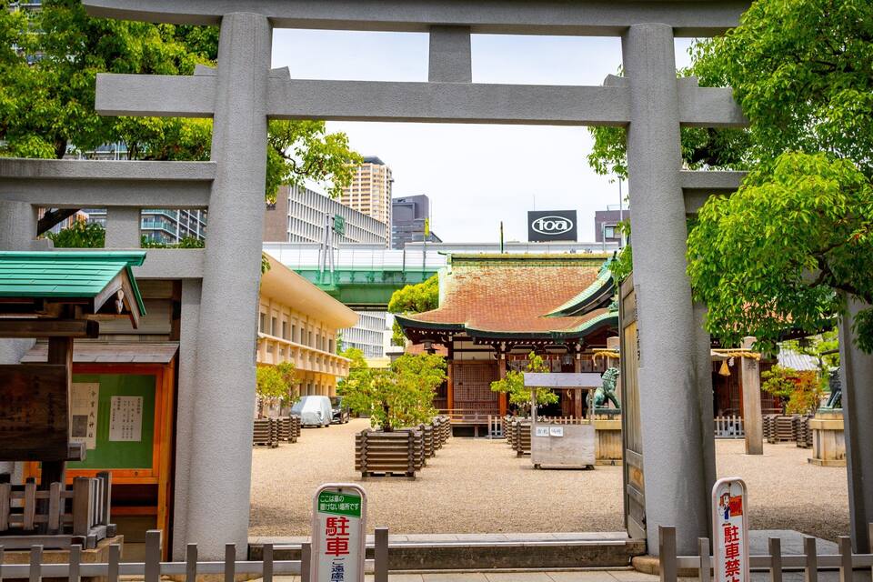 A traditional Japanese torii gate with a shrine in the background.