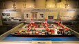 An exhibit of an automated container terminal with various shipping containers and cranes.