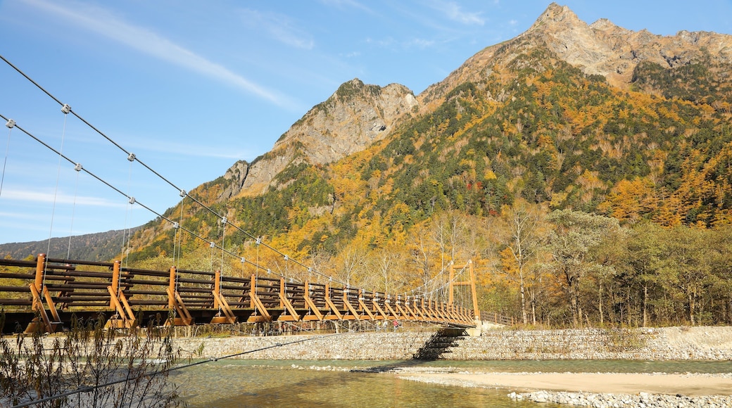 Myojin Bridge which includes a river or creek, mountains and a bridge