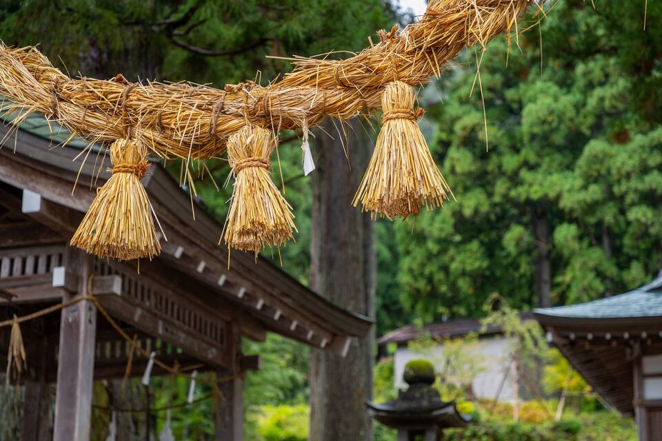 A traditional Japanese building with a straw rope decoration.