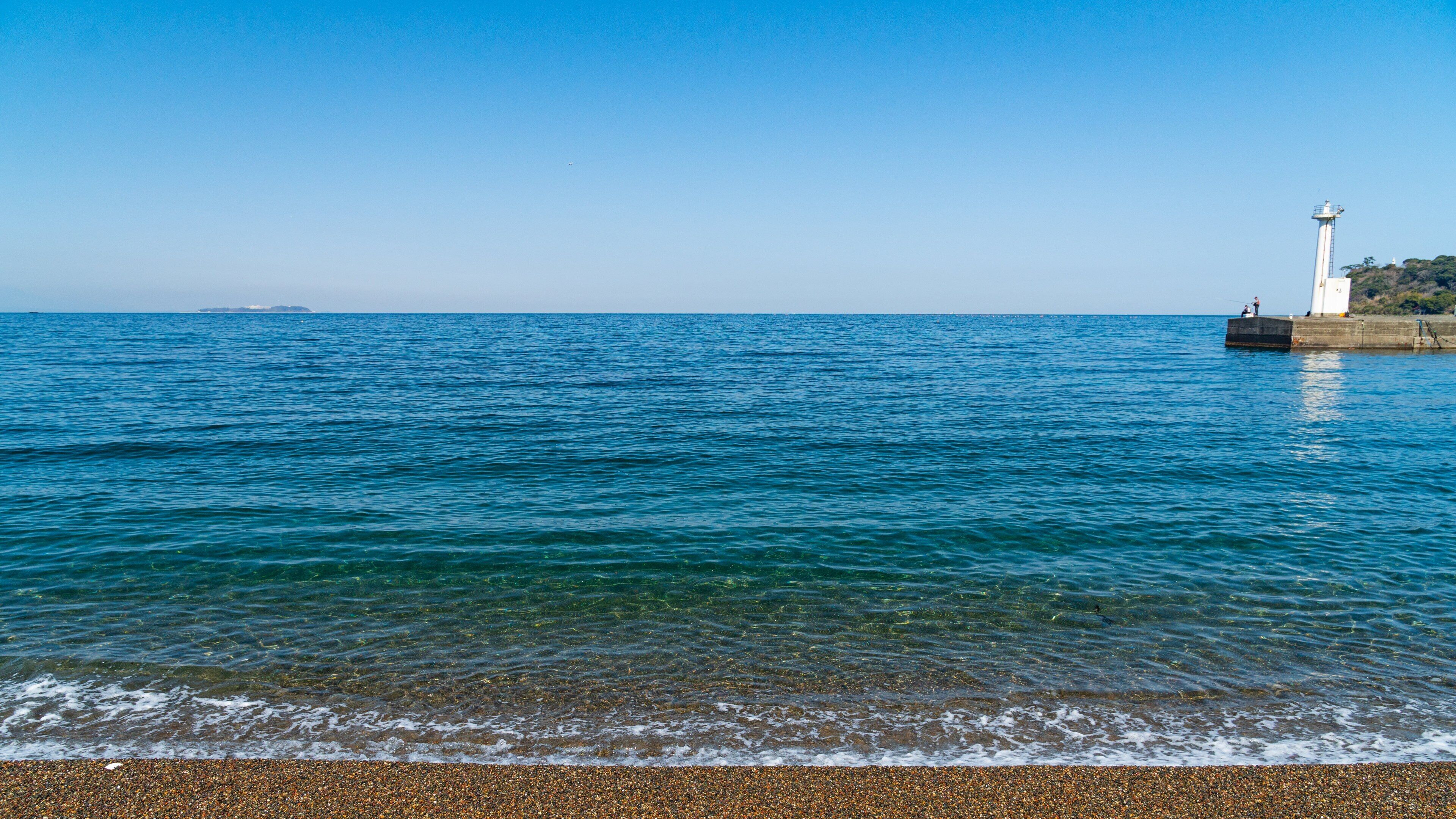 Kawana Beach showing a pebble beach, a lighthouse and general coastal views