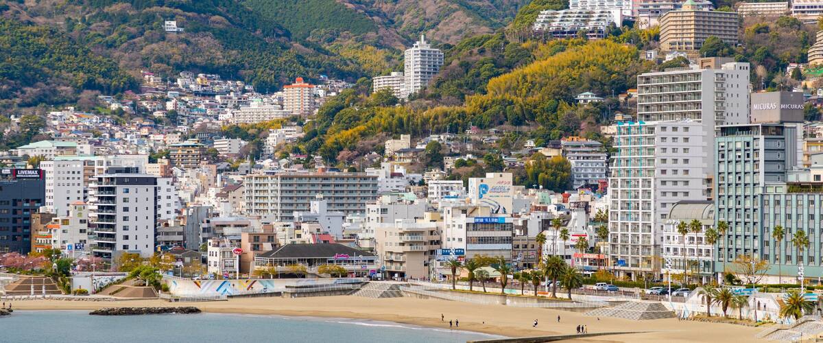 Atami Sun Beach featuring a coastal town and a city