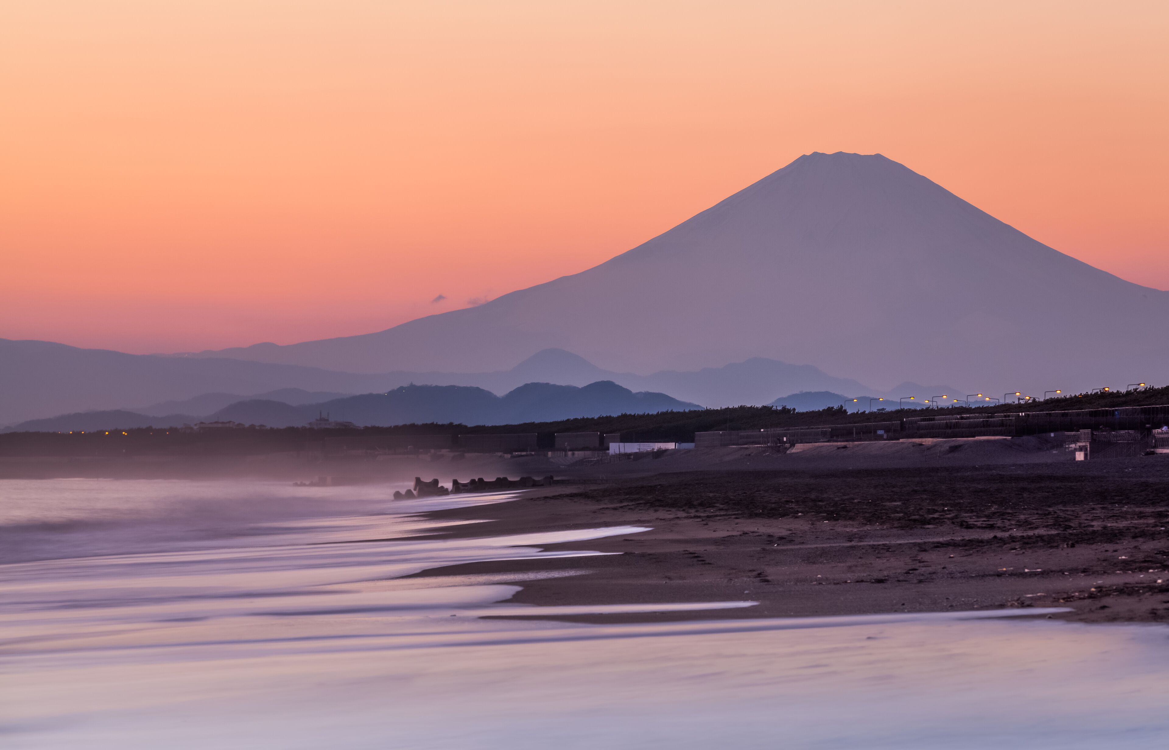 Mountain Fuji and sea wave in sunset at Southern Beach Chigasaki beach , Kanagawa prefecture , Japan