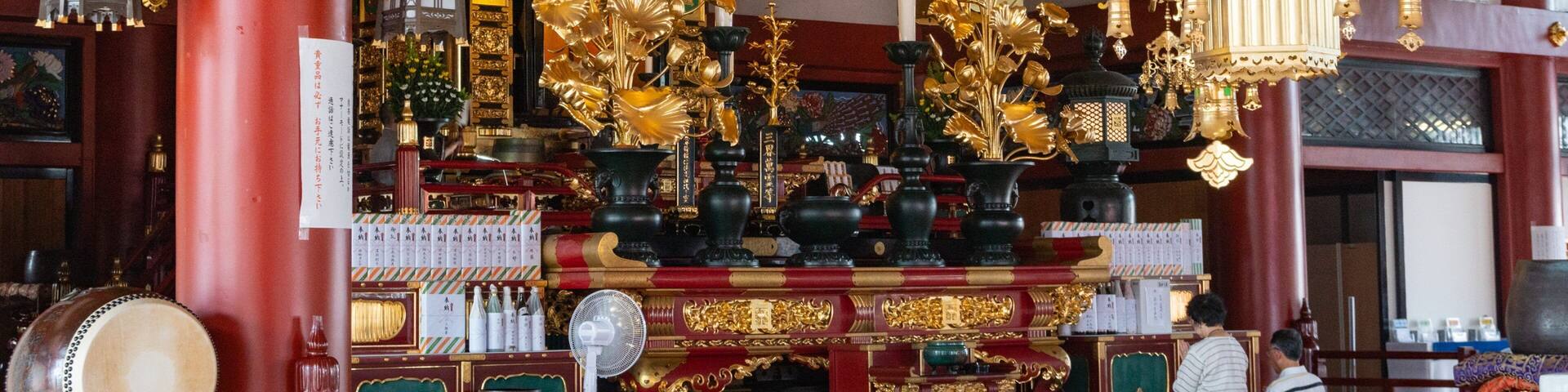 A richly decorated shrine with golden ornaments, traditional lanterns, and intricate architectural details.