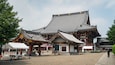 A traditional Japanese building with a curved roof and ornate wooden details.