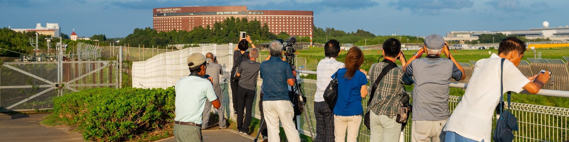 Sakura-no-Yama Hill showing views and aircraft as well as a small group of people