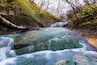 Oyunumagawa Hot spring water stream with colorful rock near Jigokudani hell valley, Noboribetsu, Hokkaido, Japan. Here is famous for visitors to heal foot by hot spring water.; Shutterstock ID 4318119