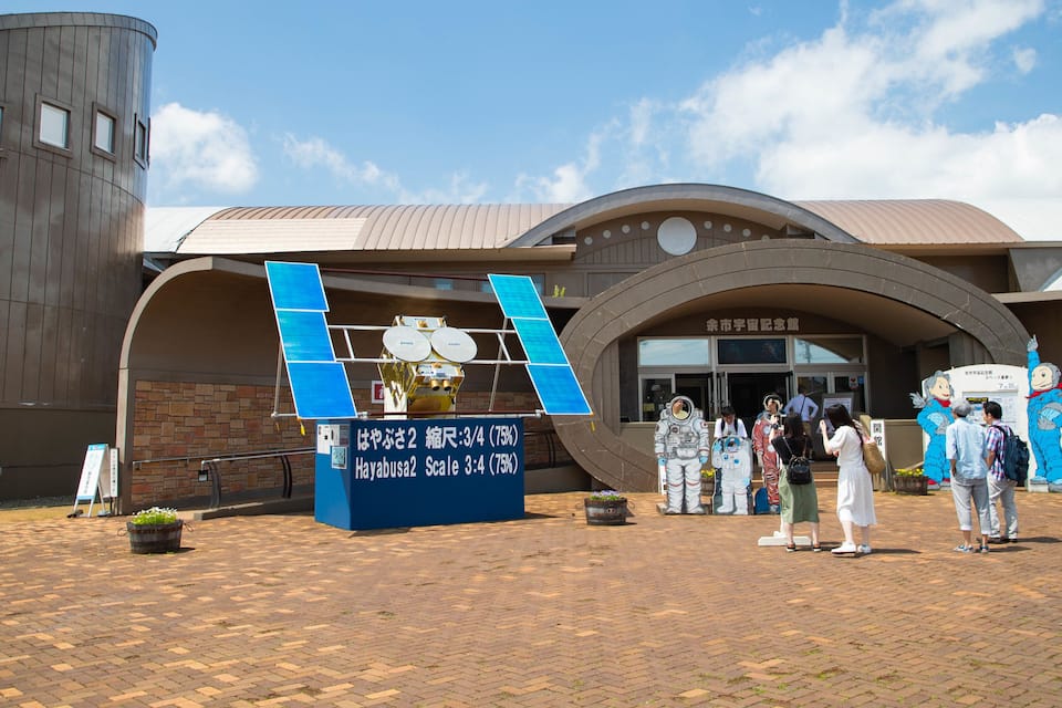 A building with a curved roof and a signboard.