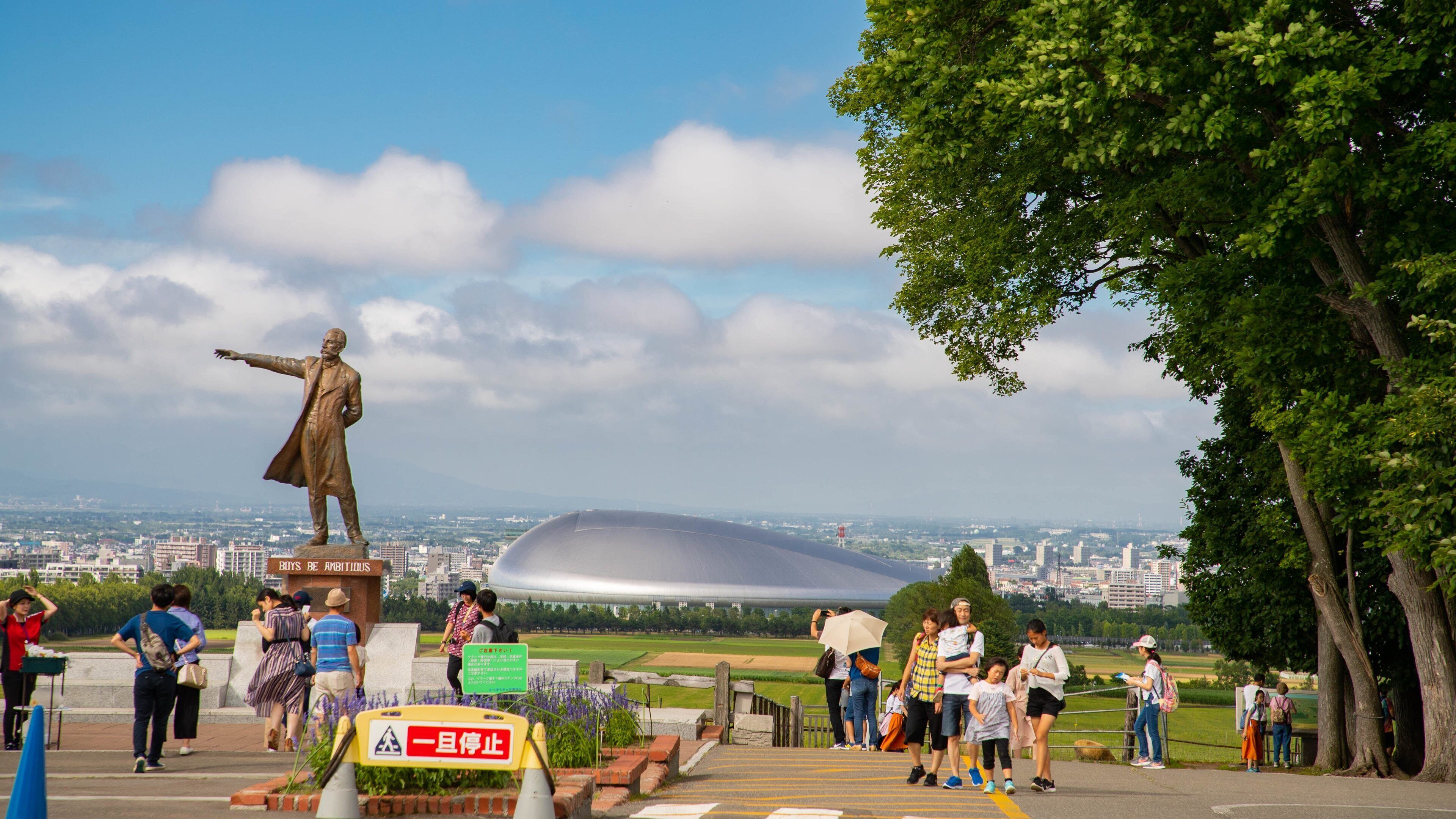 Sapporo which includes a statue or sculpture as well as a family