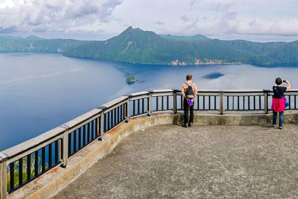 Panoramic view of Lake Mashu from the third observation deck on a late summer afternoon in Teshikaga, eastern Hokkaido, Japan.