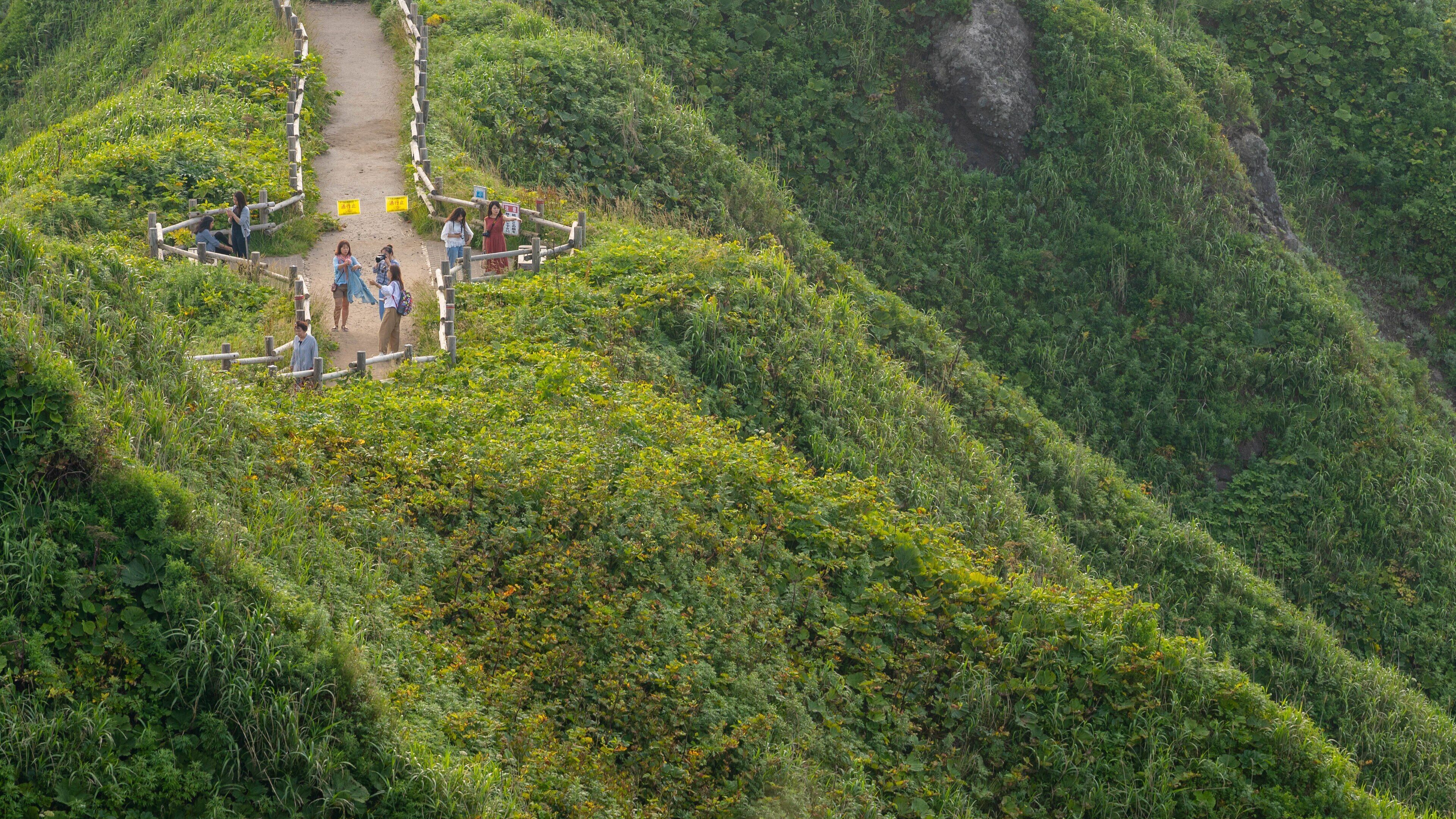 Cape Kamui which includes mountains, a sunset and landscape views