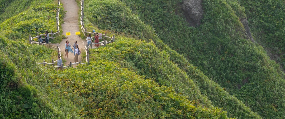 Cape Kamui which includes mountains, a sunset and landscape views
