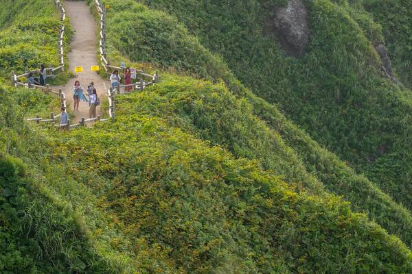 Cape Kamui which includes mountains, a sunset and landscape views