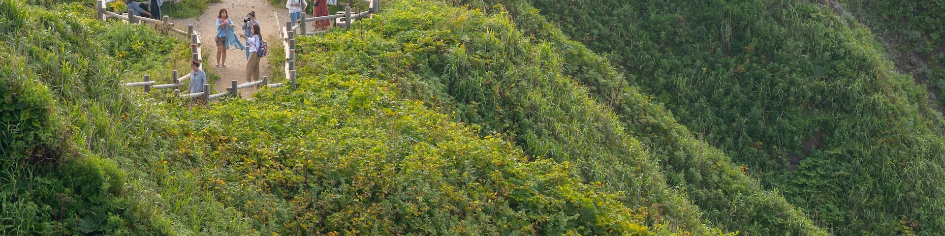 Cape Kamui which includes mountains, a sunset and landscape views