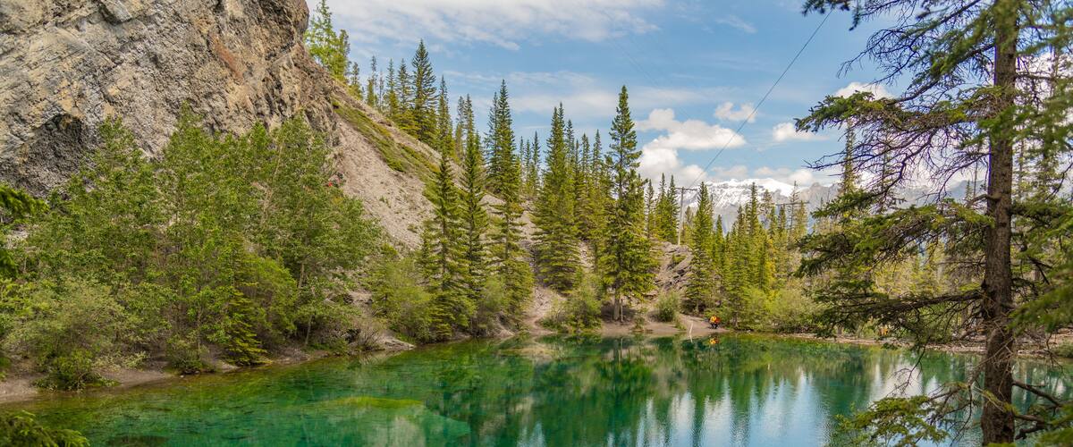 Breathtaking views of the upper and lower Grassi Lakes with brilliant turquoise and aqua waters set in a serene wilderness outside the town of Canmore near Kananaskis during the summer season.