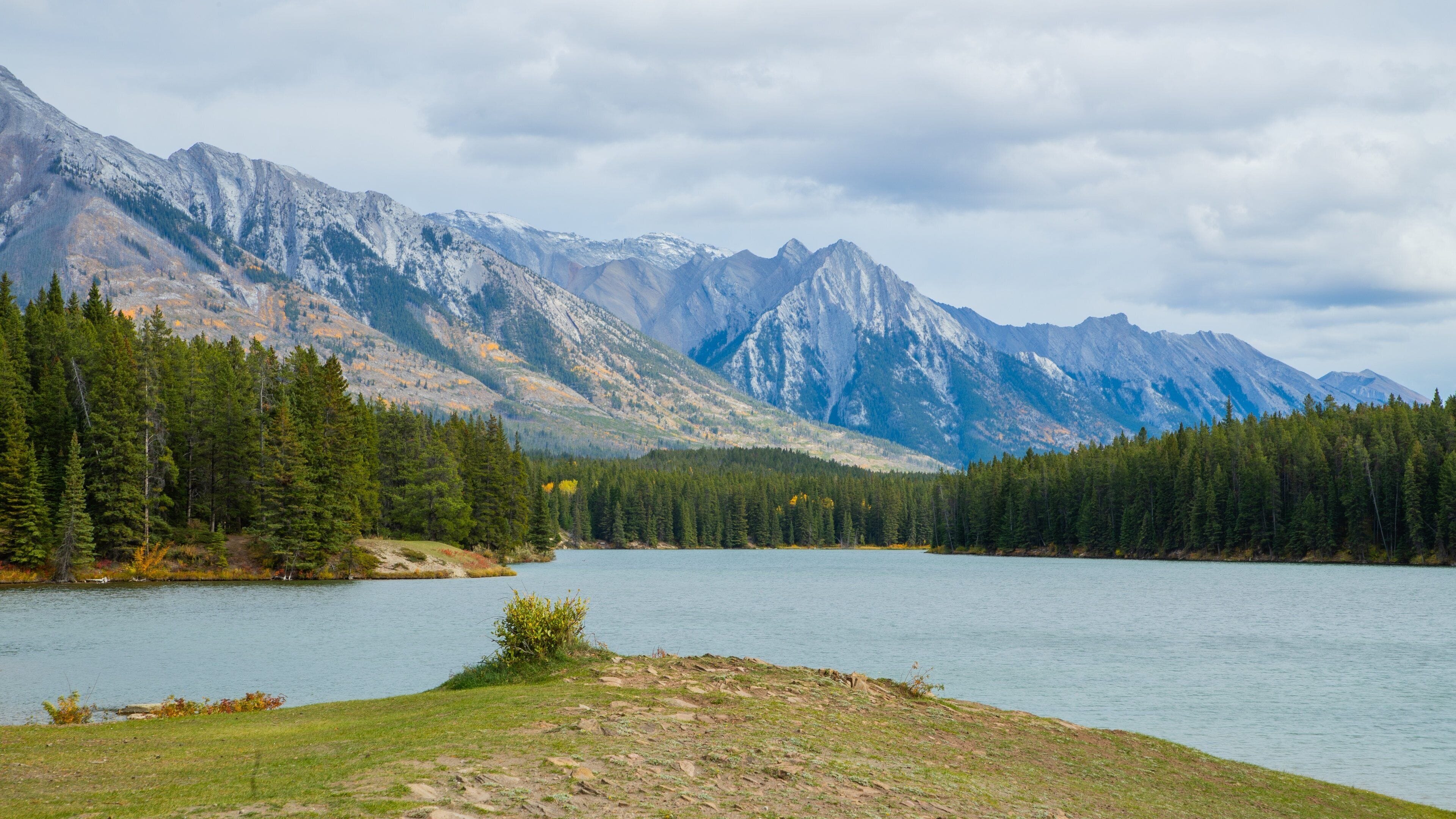 Minnewanka Loop / Lake Johnson which includes landscape views, a lake or waterhole and mountains