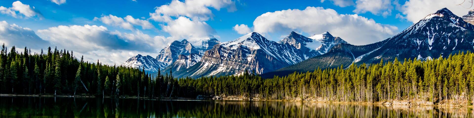 Early morning reflections in the crystal clear waters of Herbert Lake. Banff National Park, Alberta, Canada