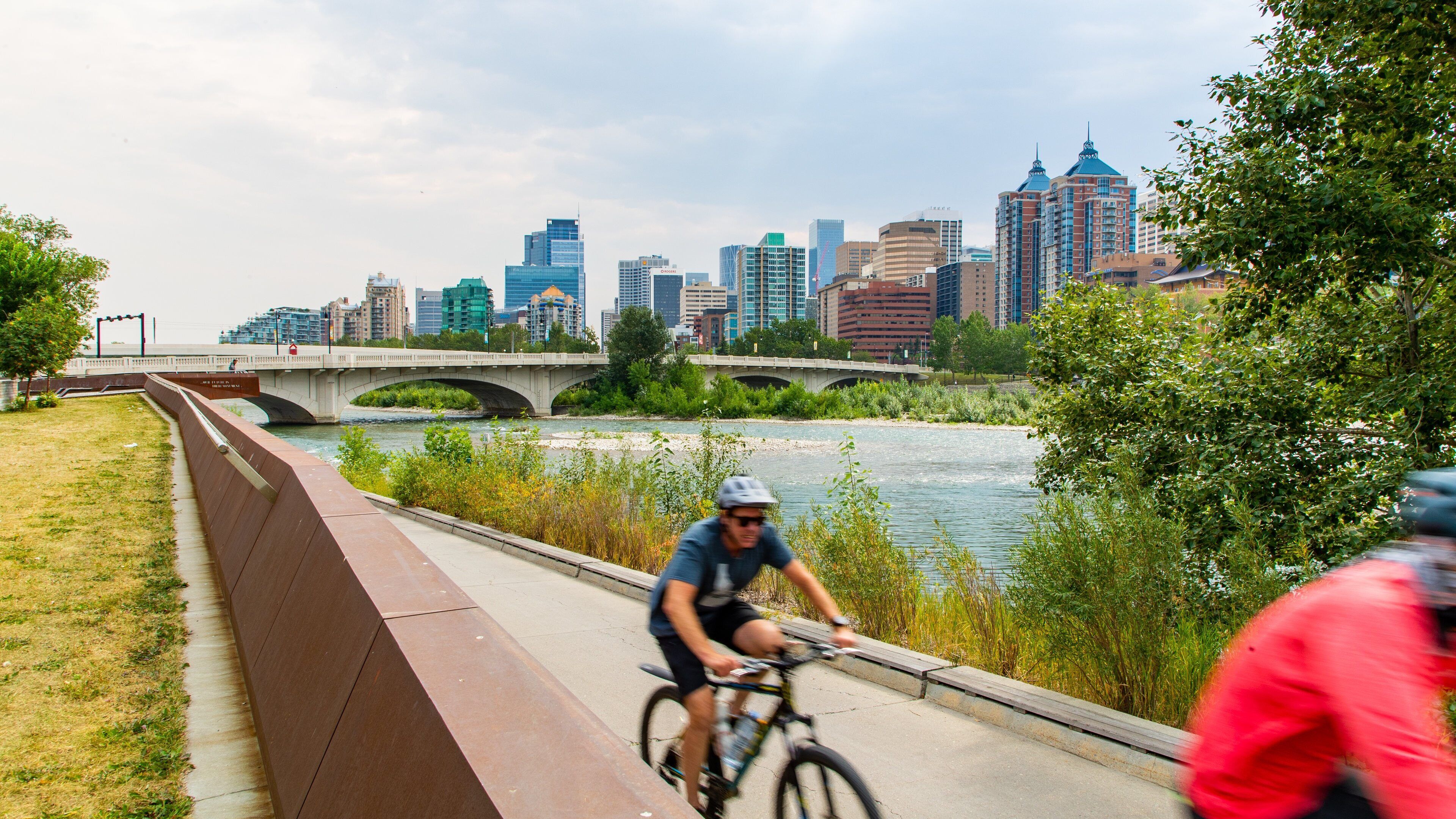 Bow River showing a bridge, cycling and a river or creek