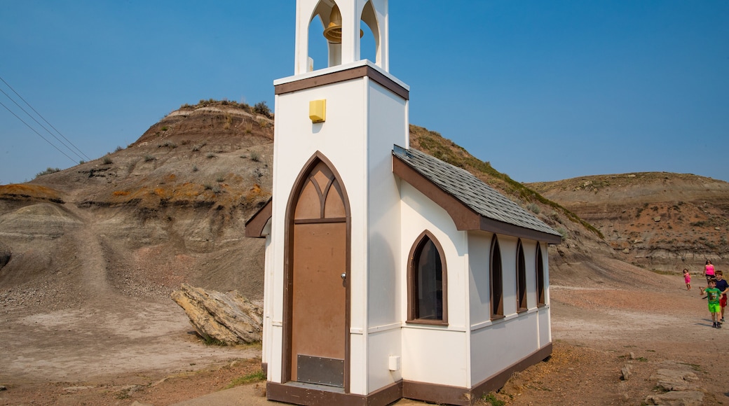 Drumheller\'s Little Church showing desert views, a church or cathedral and farmland