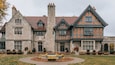 A large stone building with a brick facade and a stone chimney.