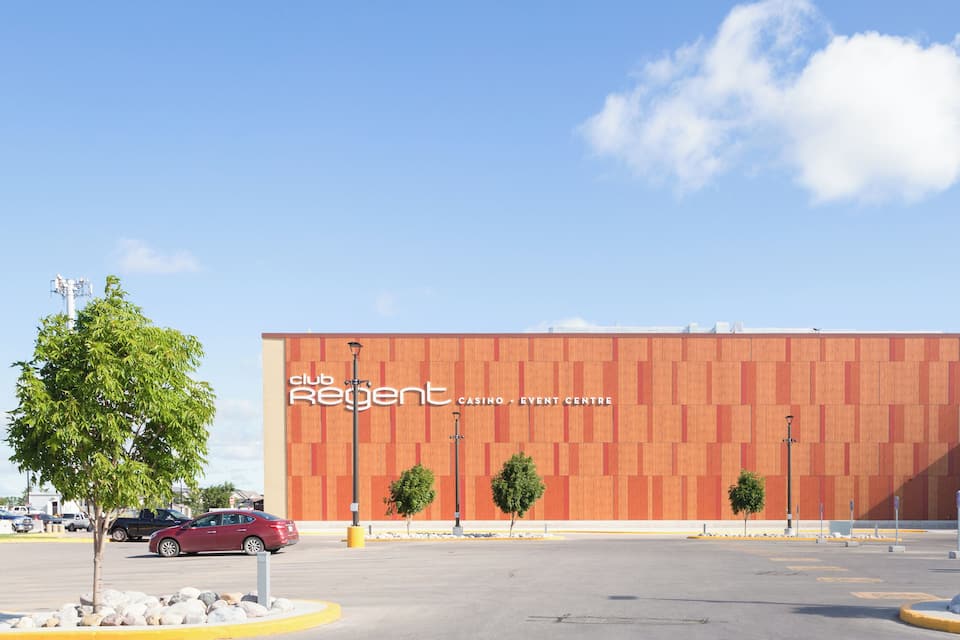 A modern building with a wooden facade and the text "club Regent Casino Event Centre" on it.