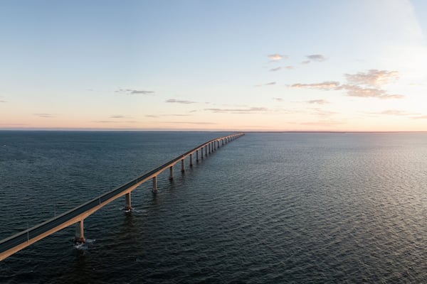 Aerial Panoramic view of Confederation Bridge to Prince Edward Island during a vibrant sunny sunrise. Taken in Cape Jourimain National Wildlife Area, New Brunswick, Canada.