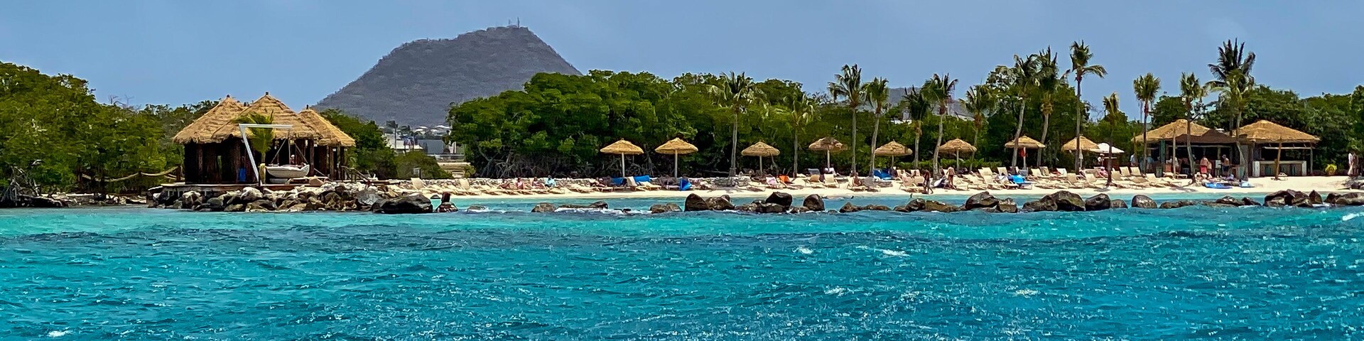 Renaissance Island private beach for guests of Renaissance Wind Creek Aruba Resort. Hooiberg (Haystack) mountain in the distance.