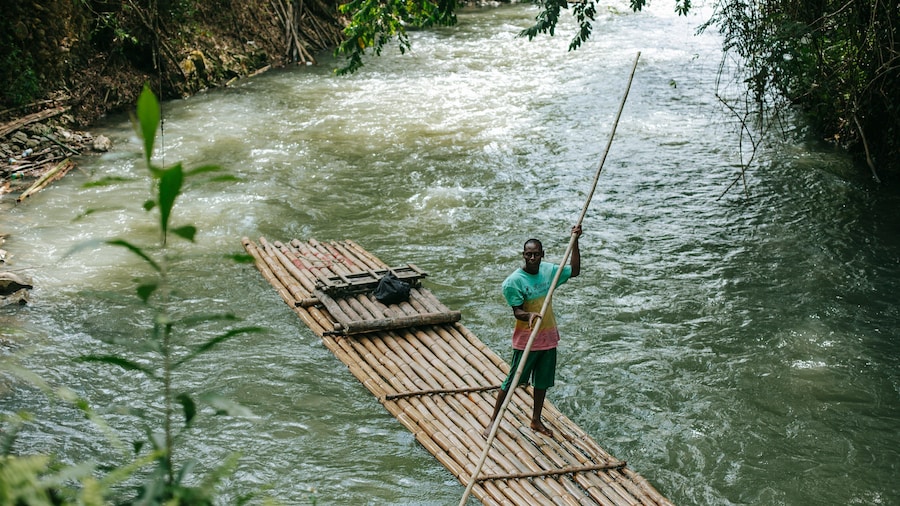 Martha Brae River showing a river or creek and kayaking or canoeing as well as an individual male