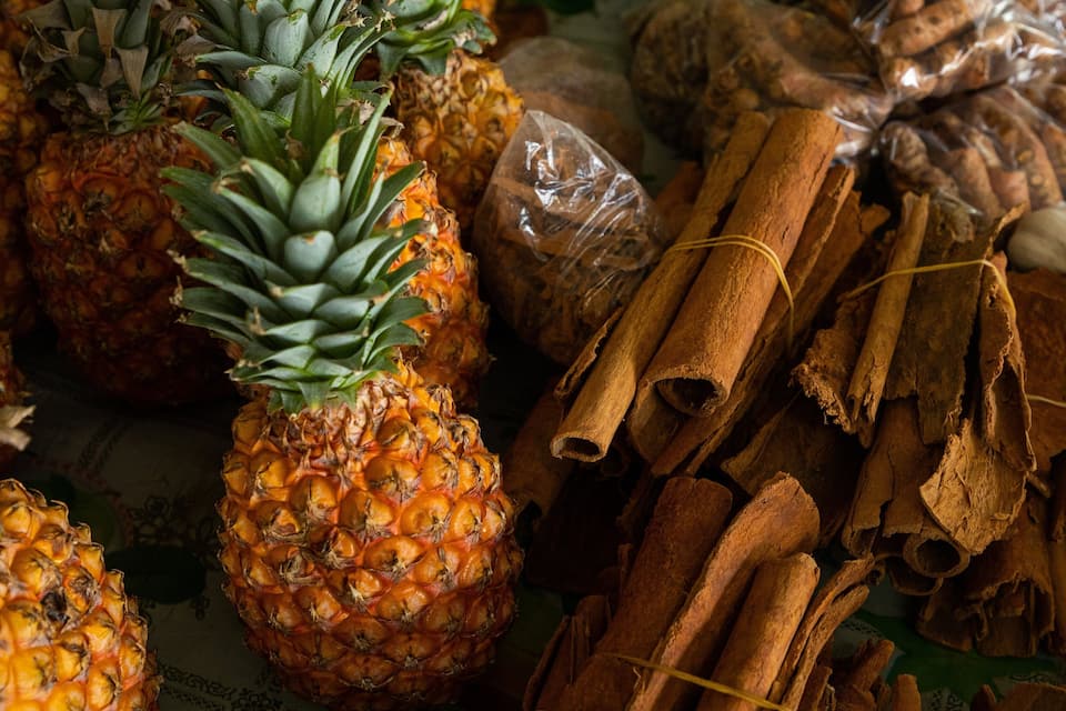 Pineapples, cinnamon sticks, and garlic cloves.