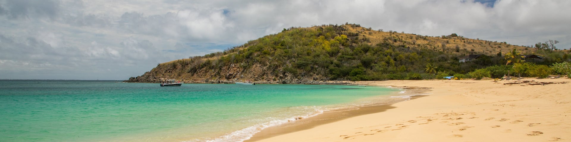Happy Bay Beach which includes a sandy beach and general coastal views
