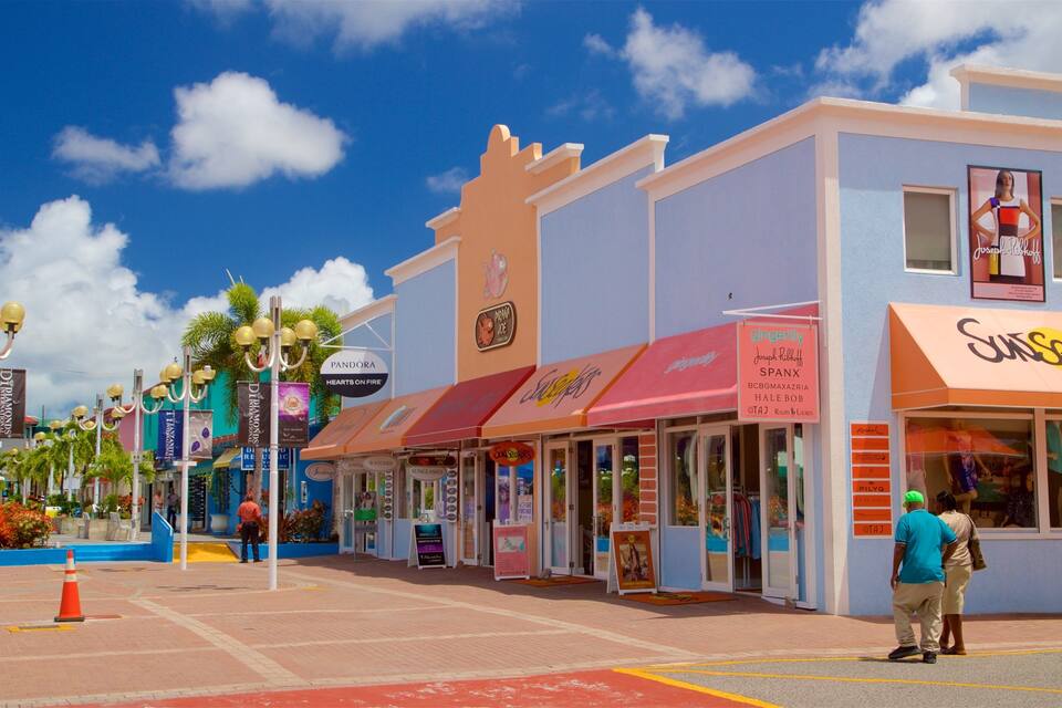 A vibrant street with shops like Pandora Hearts on Fire, Ginger Lily, and Sunseeker.
