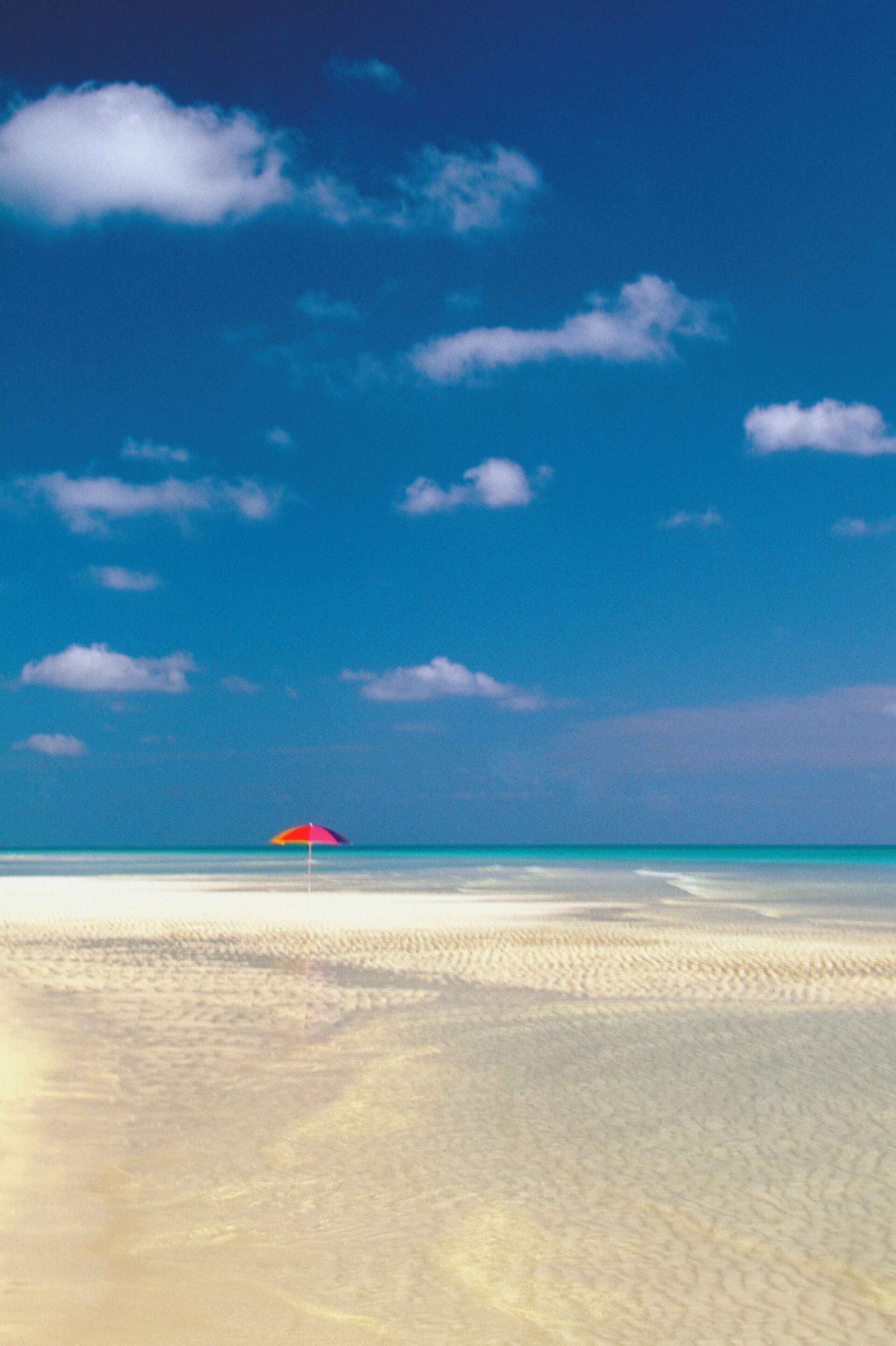 One red umbrella on beach in Lucayan National Park on Grand Bahama Island, Caribbean