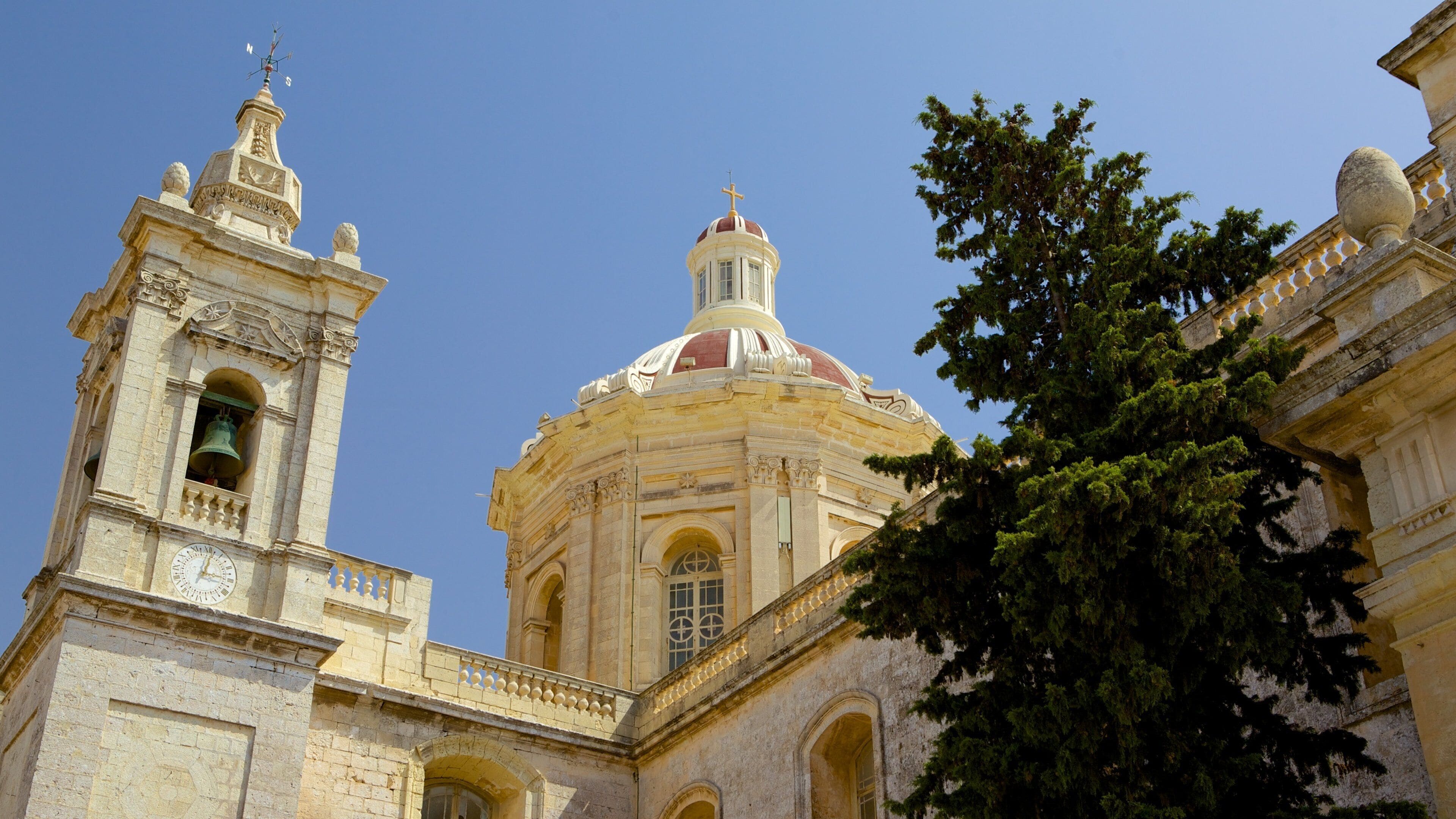 A historic building with a prominent bell tower and a large dome.