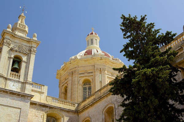 A historic building with a prominent bell tower and a large dome.