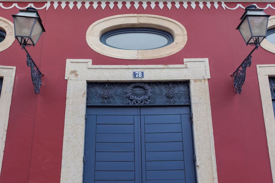 Teatro Luís de Camões with a blue door, a number '78' sign, and ornate decorations.