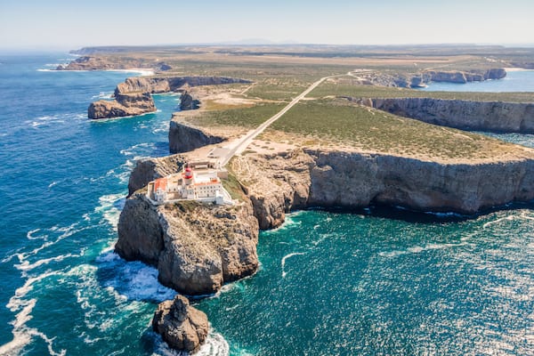 Beautiful lighthouse located on high cliffs of Saint Vincent cape in Algarve, Portugal