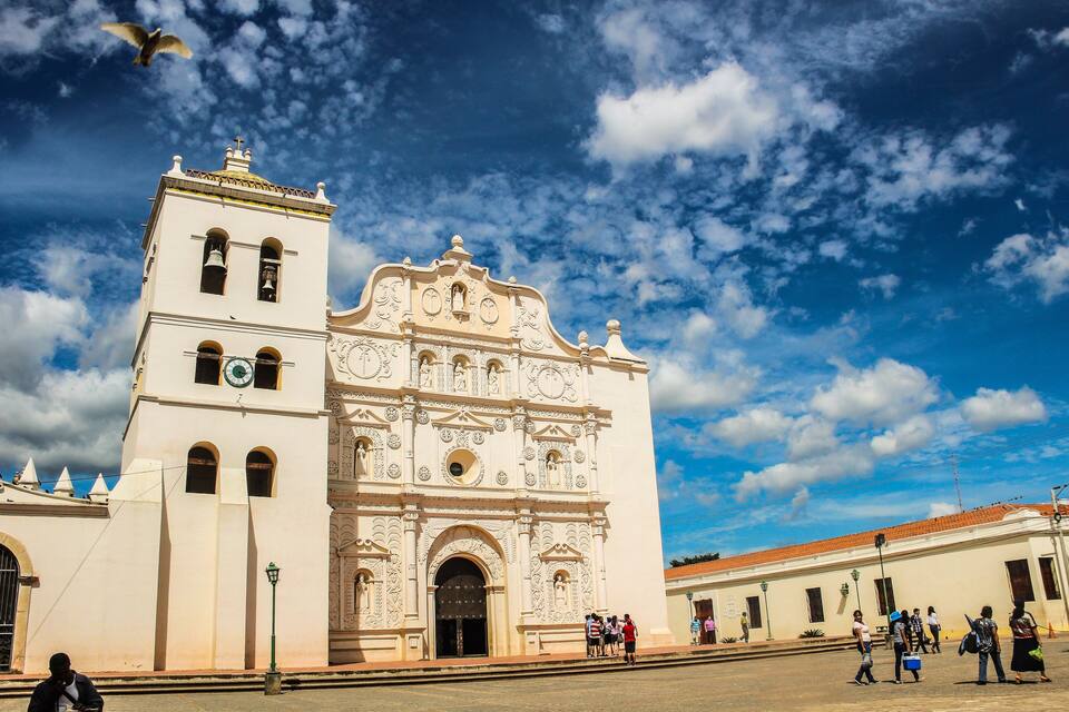 A historic white church with ornate architecture and a bell tower.