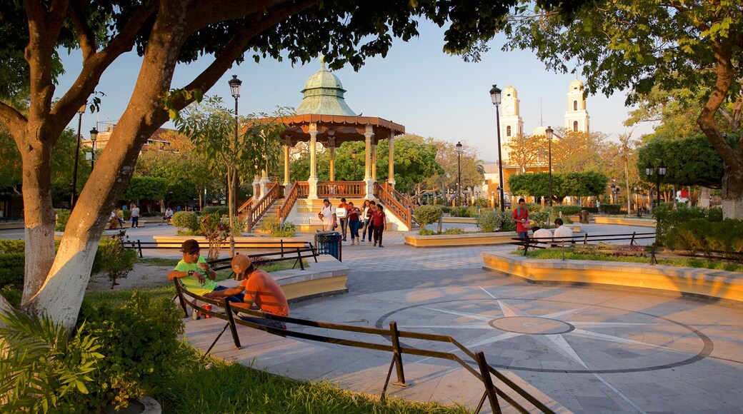 Zaragoza Park featuring a sunset and a park as well as a small group of people