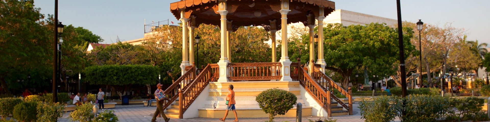 Zaragoza Park which includes a garden and a sunset as well as a couple