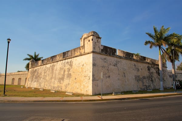 Baluarte de San Juan which includes heritage architecture and a sunset