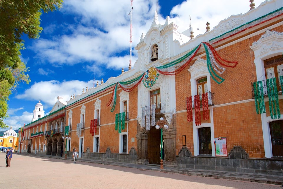 A historic building with ornate architecture, decorated with colorful garlands.