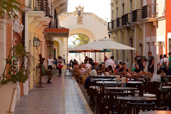 Sea Gate featuring outdoor eating as well as a small group of people