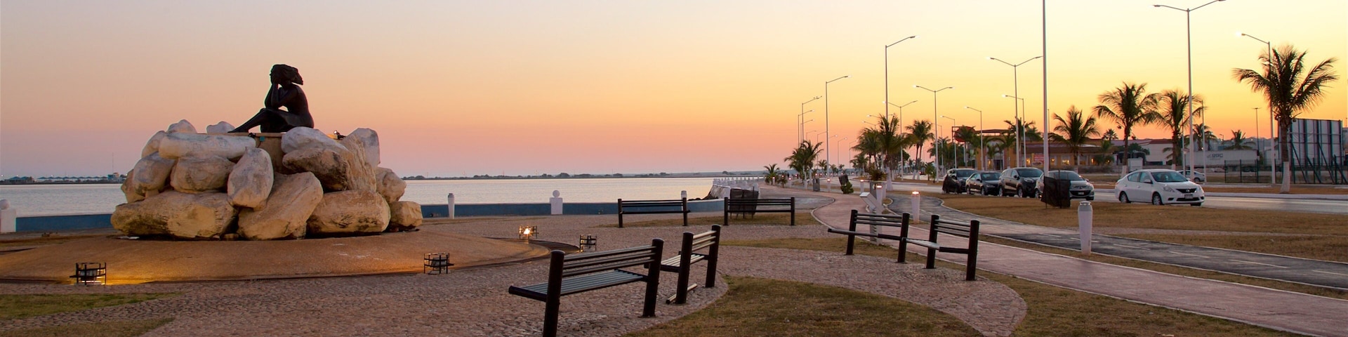 Novia del Mar Monument showing a garden, outdoor art and a sunset