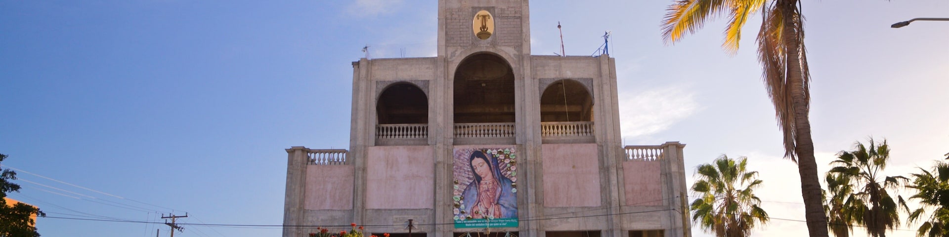 Sanctuary of the Virgen of Guadalupe which includes heritage architecture, a church or cathedral and a sunset