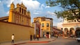 Plaza 31 de Marzo featuring a church or cathedral and heritage elements as well as a small group of people