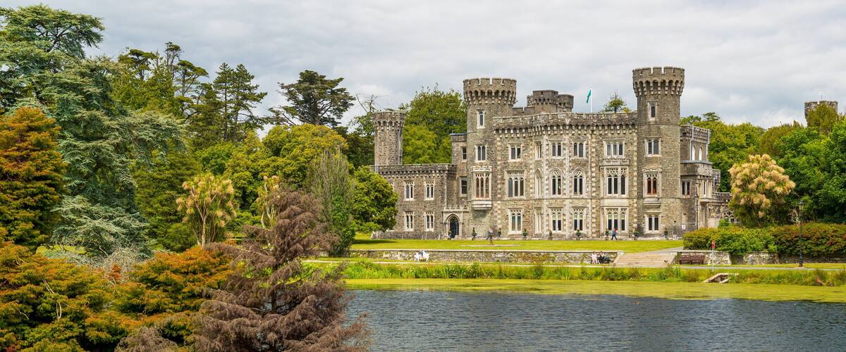 Johnstown Castle & Gardens featuring a lake or waterhole, heritage architecture and a castle