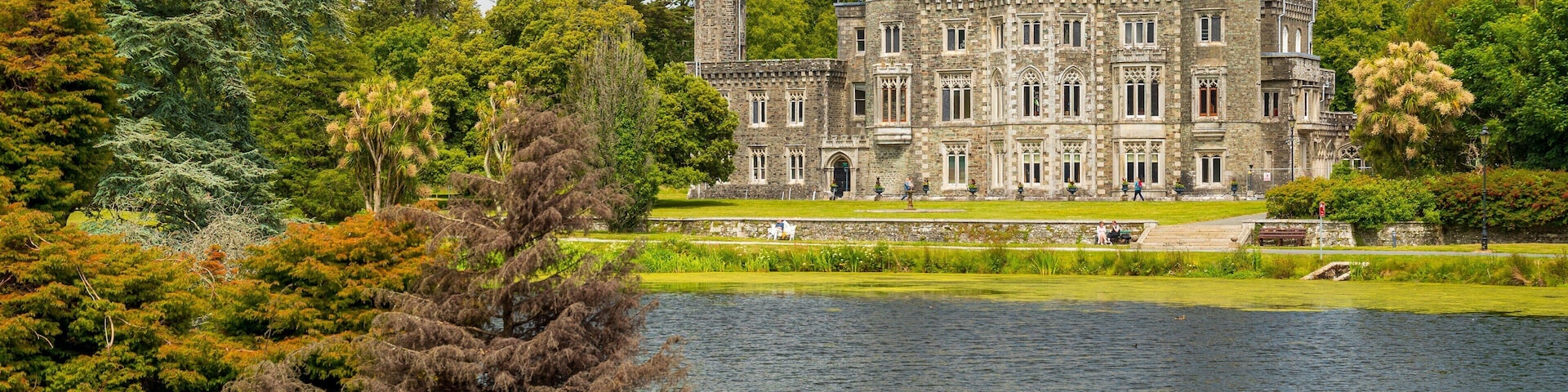 Johnstown Castle & Gardens featuring a lake or waterhole, heritage architecture and a castle